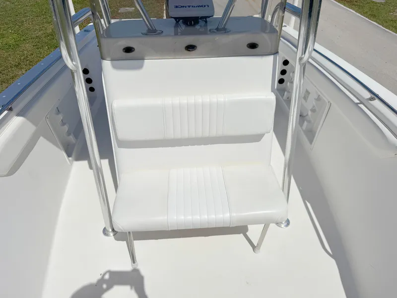 Slide: The Image of 2005 Sea Chaser 2100 Offshore boat seating area with white cushioned bench. - 10