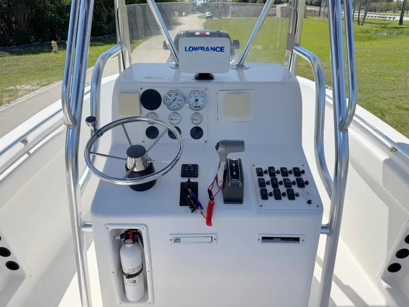 Slide: The Image of 2005 Sea Chaser 2100 Offshore boat console with steering wheel and navigation equipment. - 14