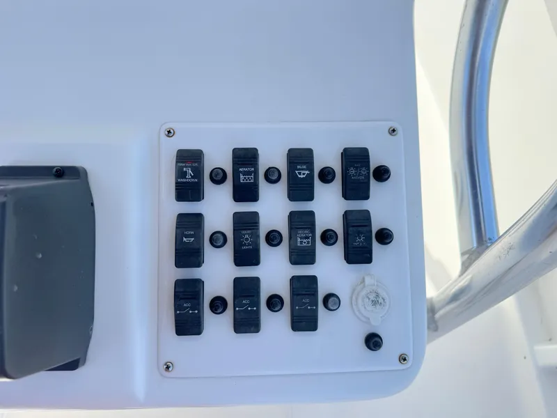 Slide: The Image of Control panel of a 2005 Sea Chaser 2100 Offshore boat with multiple switches. - 17