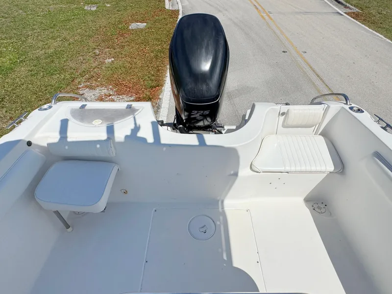 Slide: The Image of 2005 Sea Chaser 2100 Offshore boat interior with seating and outboard motor. - 19
