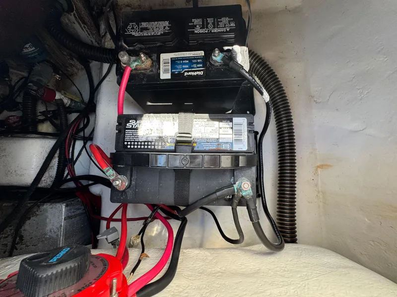 Slide: The Image of Battery setup in a 2005 Sea Chaser 2100 Offshore boat, featuring wiring and connections. - 27