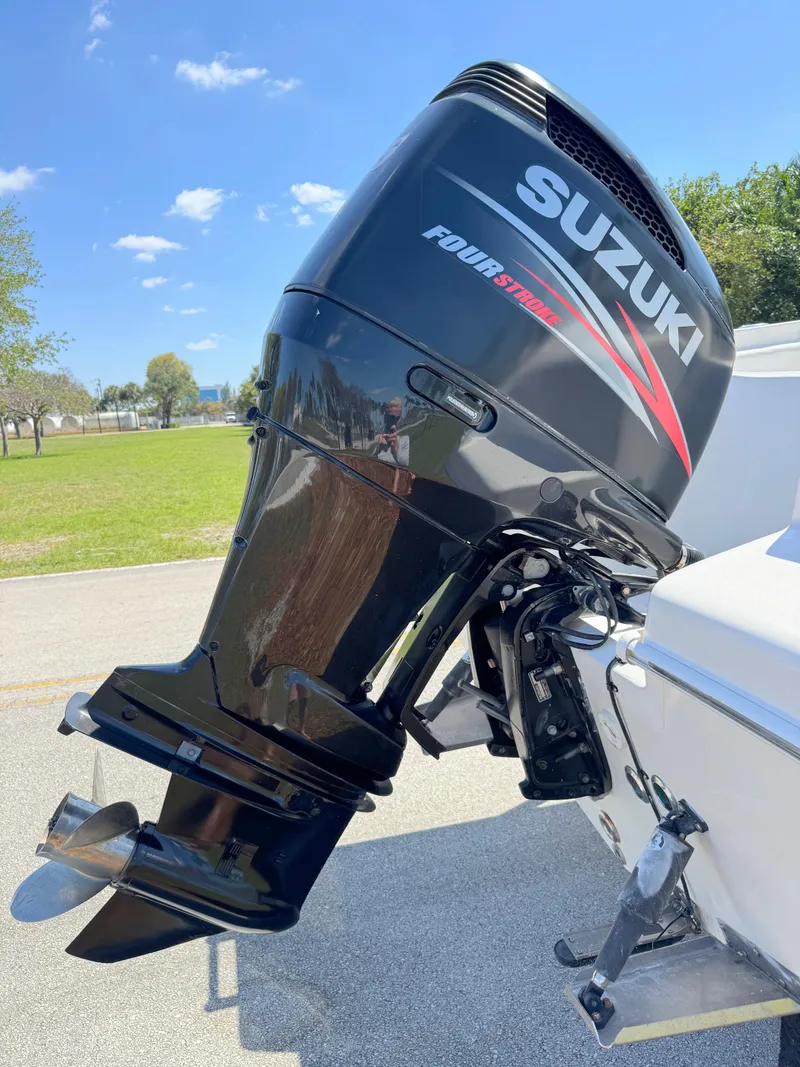 Slide: The Image of 2005 Sea Chaser 2100 Offshore with Suzuki four-stroke outboard motor, parked outdoors. - 30