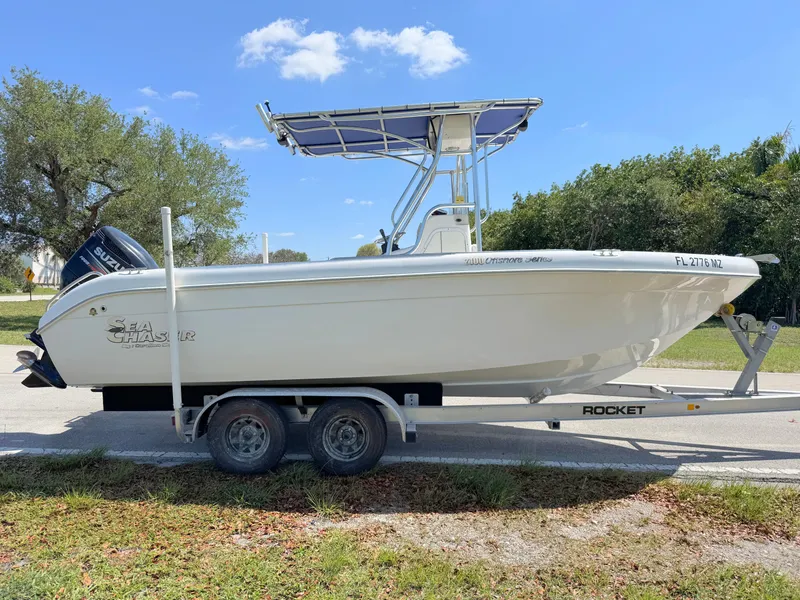 Slide: The Image of 2005 Sea Chaser 2100 Offshore boat on trailer, parked outdoors under blue sky. - 5