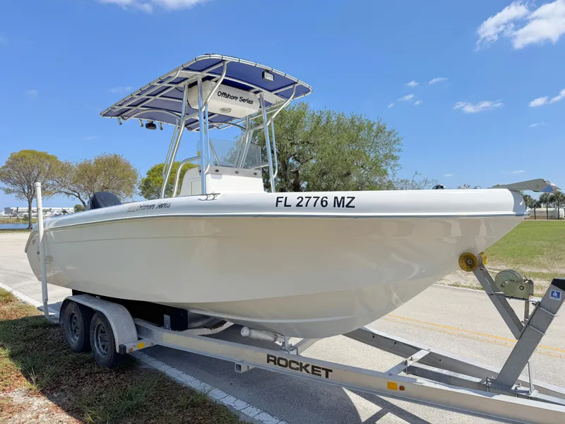 Slide: The Image of 2005 Sea Chaser 2100 Offshore boat on trailer, parked outdoors under blue sky. - 6