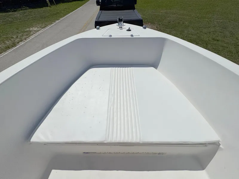 Slide: The Image of 2005 Sea Chaser 2100 Offshore boat interior with white seating, parked on a road. - 8