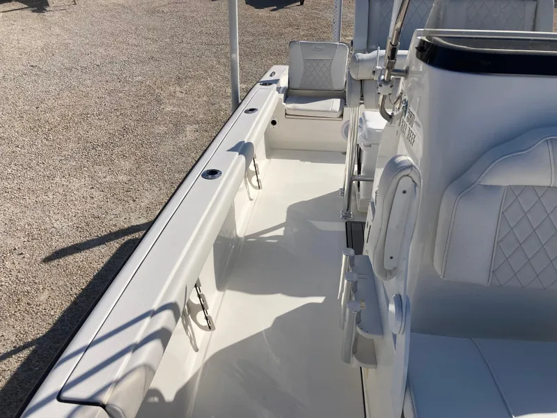 Slide: The Image of 2025 Key West 250BR boat interior with white seating and sleek design. - 12