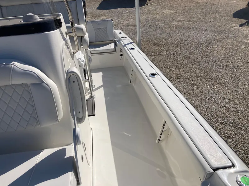 Slide: The Image of 2025 Key West 250BR boat interior with white seating and deck. - 13