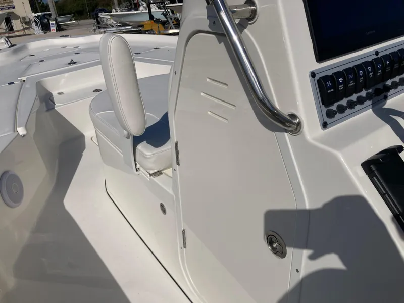 Slide: The Image of 2025 Key West 250BR boat interior with white seating and control panel. - 14