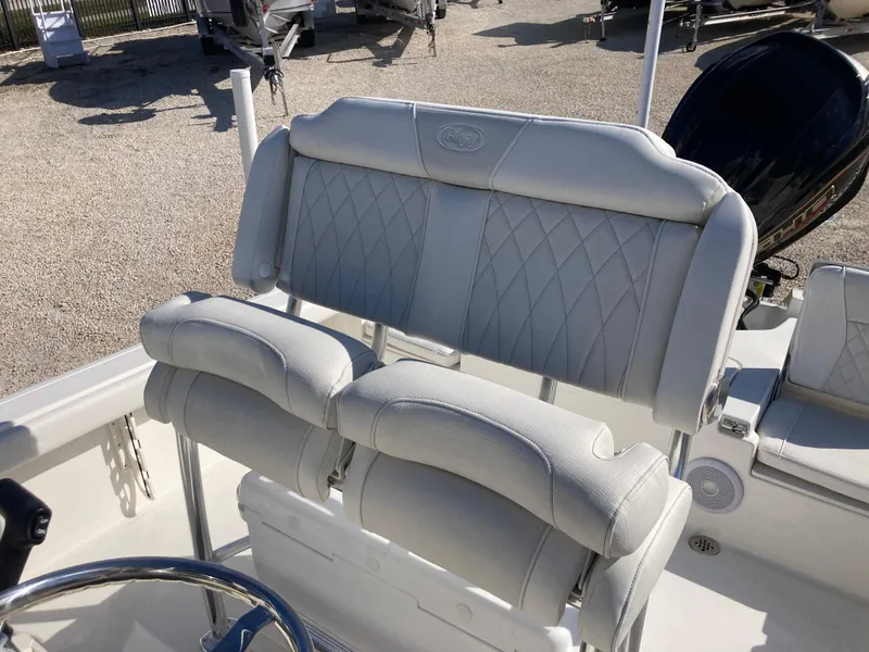 Slide: The Image of 2025 Key West 250BR boat with white cushioned seating and steering wheel. - 16