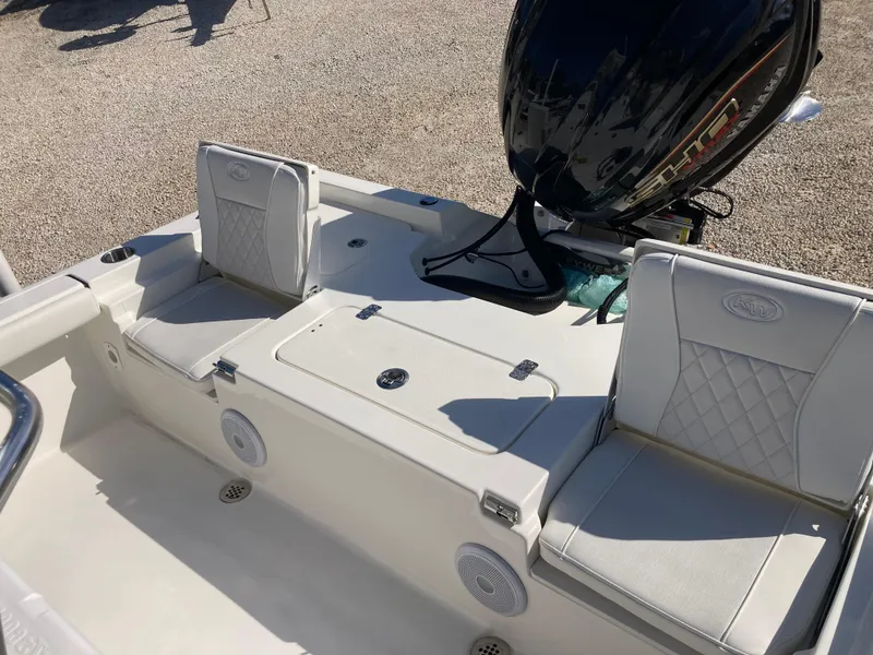Slide: The Image of 2025 Key West 250BR boat interior with cushioned seating and outboard motor. - 18