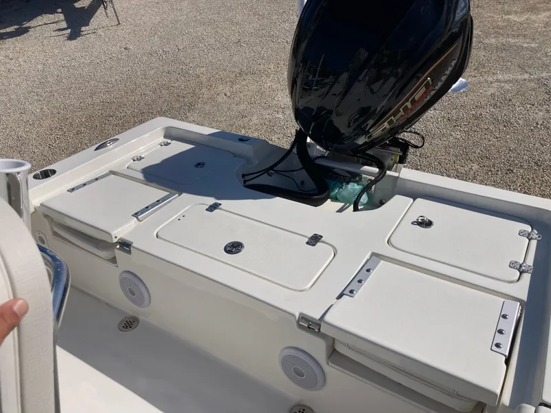 Slide: The Image of 2025 Key West 250BR boat deck with motor, featuring storage compartments and speakers. - 19