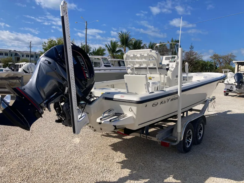 Slide: The Image of 2025 Key West 250BR boat on trailer, parked outdoors under blue sky. - 3