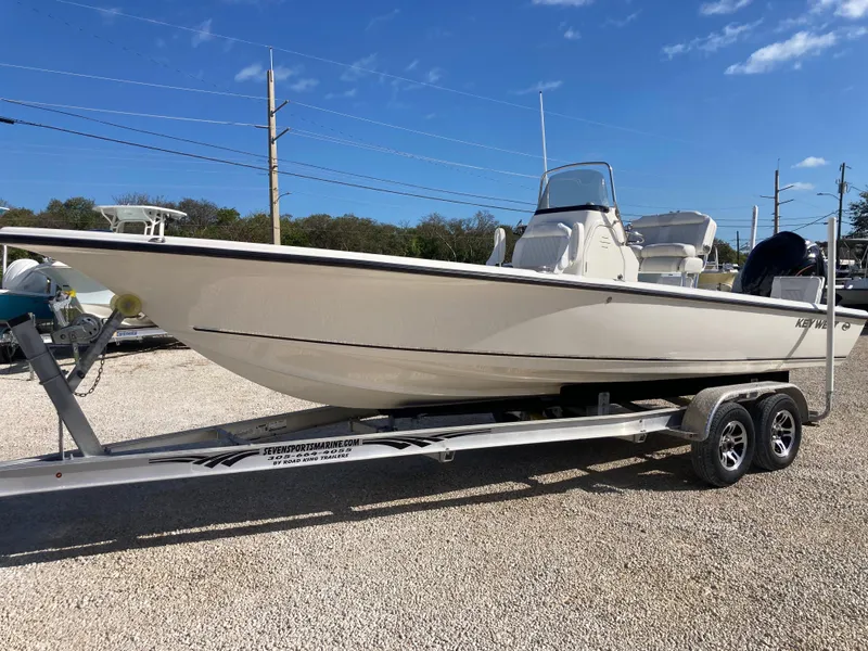 Slide: The Image of 2025 Key West 250BR boat on trailer, parked outdoors under clear blue sky. - 5