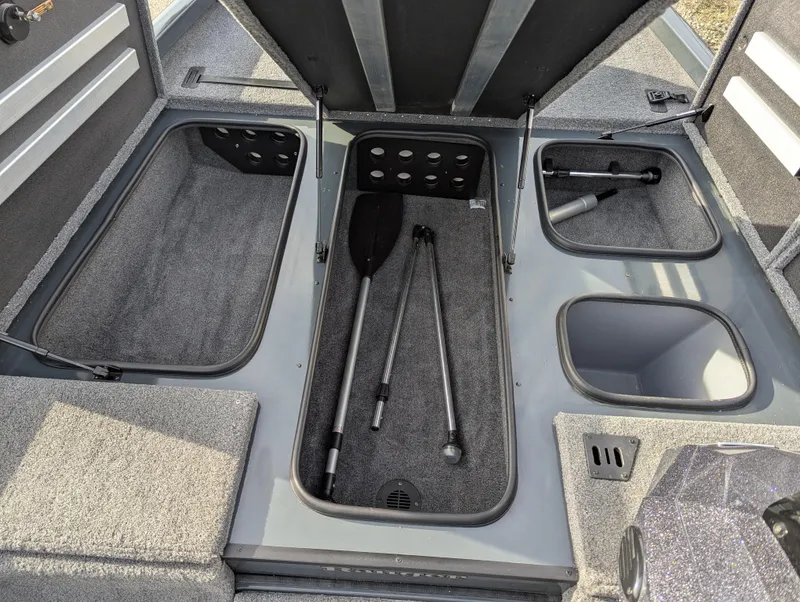 Slide: The Image of 2023 Ranger RT188P boat storage compartments with paddles and equipment. - 16