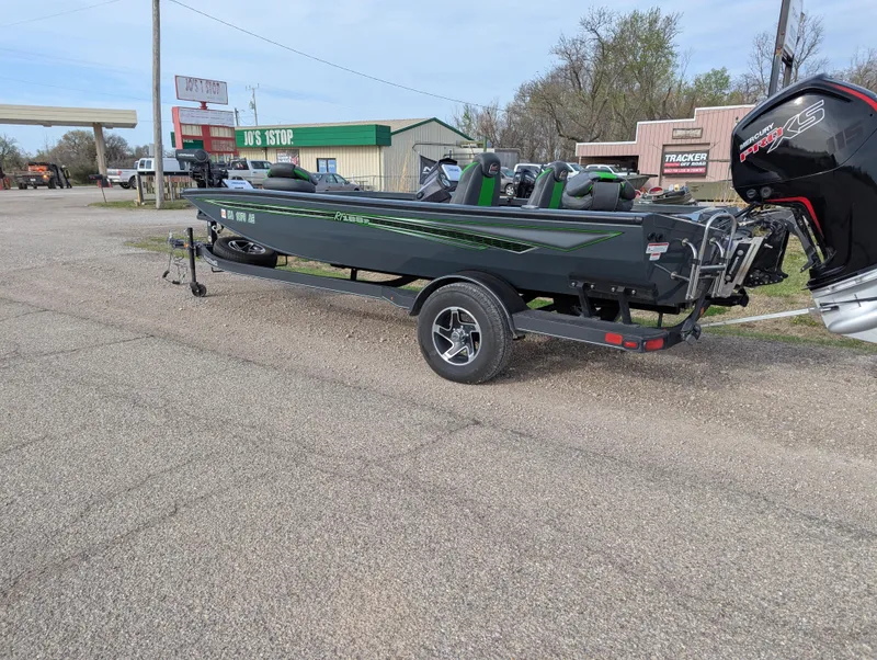Slide: The Image of 2023 Ranger RT188P boat on trailer, parked in a lot near shops. - 3