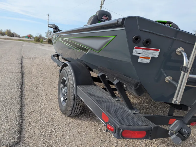 Slide: The Image of 2023 Ranger RT188P boat on trailer, parked on roadside, showcasing sleek design and green accents. - 4