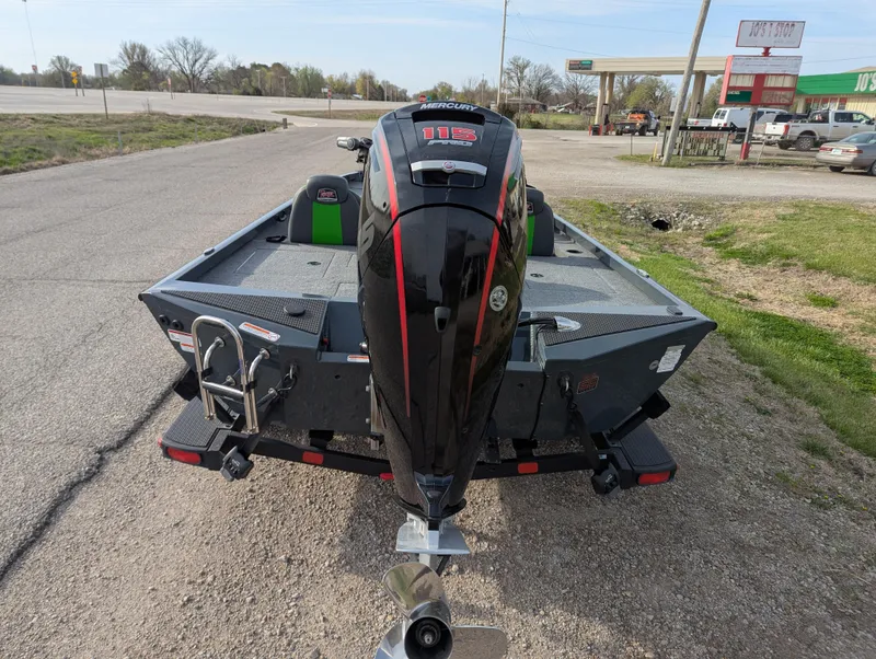 Slide: The Image of 2023 Ranger RT188P boat with powerful outboard motor, parked on a roadside. - 5