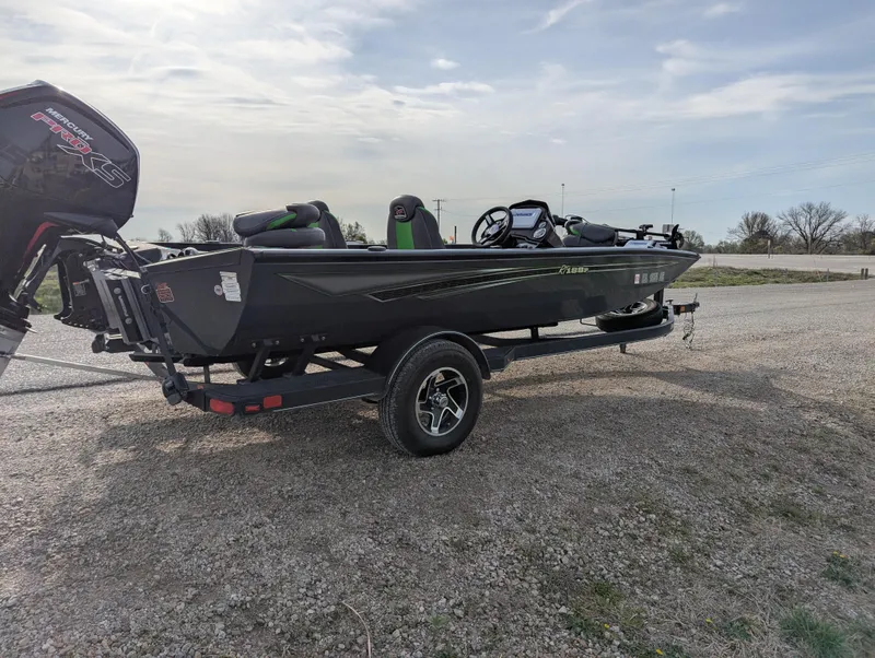 Slide: The Image of 2023 Ranger RT188P boat on trailer, parked on gravel under cloudy sky. - 7