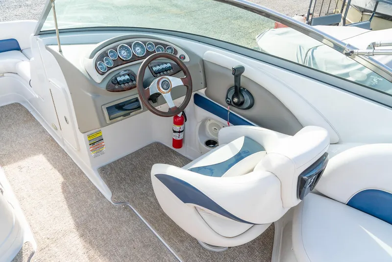 Slide: The Image of 2012 Crownline Eclipse E2 boat interior with steering wheel and dashboard controls. - 15
