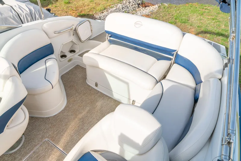 Slide: The Image of 2012 Crownline Eclipse E2 boat interior with white and blue seating, carpeted floor. - 21
