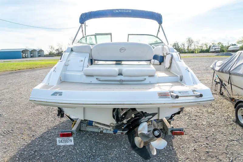 Slide: The Image of 2012 Crownline Eclipse E2 boat, rear view, on a trailer in a sunny outdoor setting. - 7