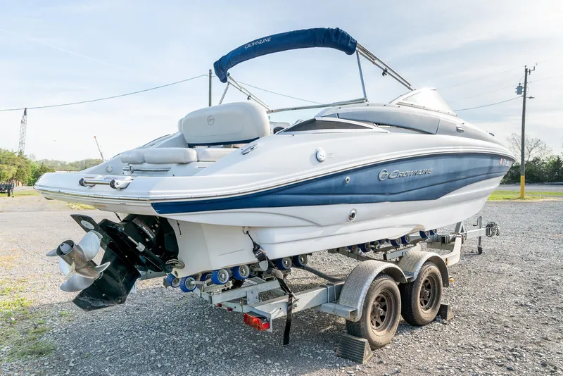 Slide: The Image of 2012 Crownline Eclipse E2 boat on trailer, featuring sleek design and blue accents. - 9