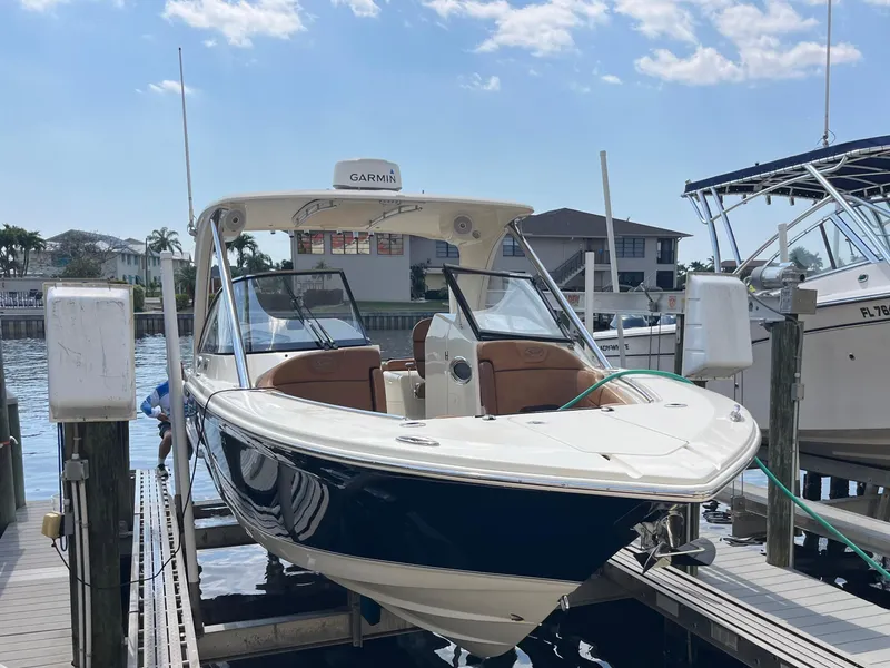 Slide: The Image of 2015 Scout 275 Dorado boat docked at marina under clear sky. - 3