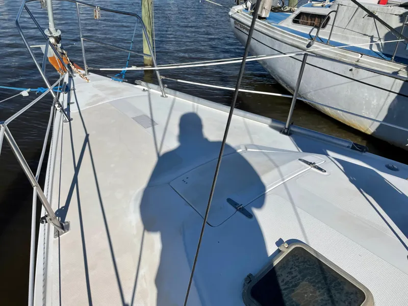 Slide: The Image of Shadow on deck of 1982 Catalina 30 sailboat, docked beside another vessel. - 11