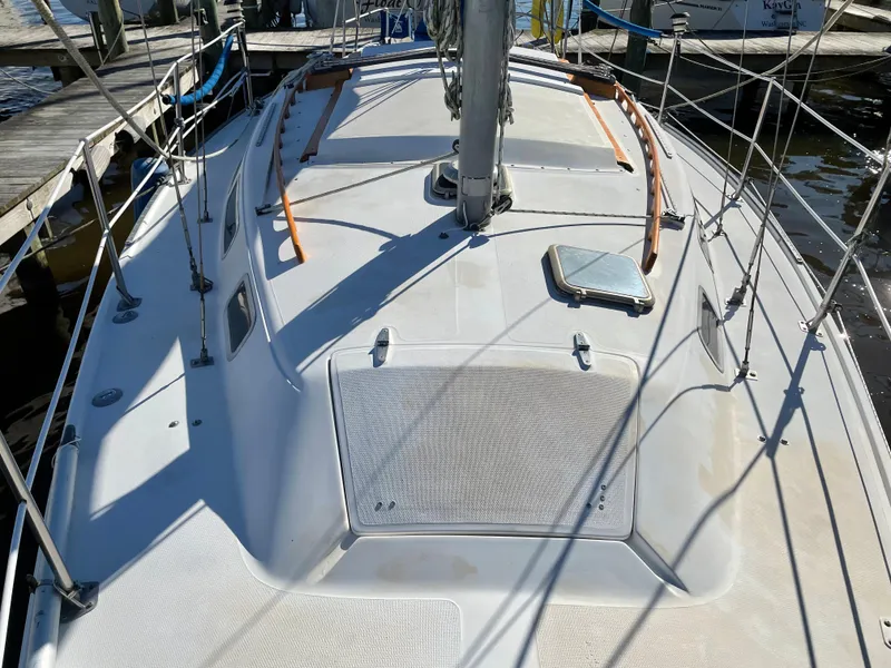 Slide: The Image of 1982 Catalina 30 sailboat deck view at marina, showcasing mast and rigging. - 12