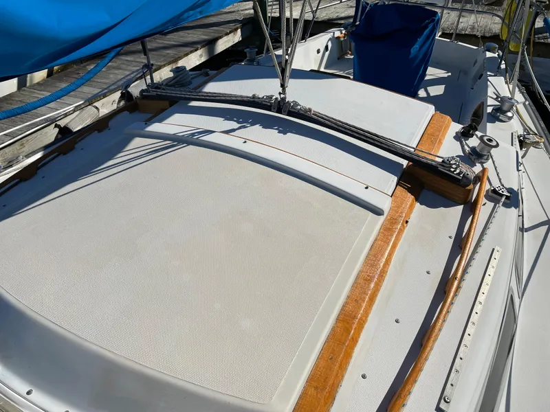 Slide: The Image of 1982 Catalina 30 sailboat deck with blue cover and wooden trim. - 14