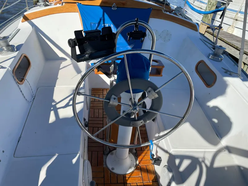 Slide: The Image of Cockpit of 1982 Catalina 30 sailboat with steering wheel and wooden flooring. - 18