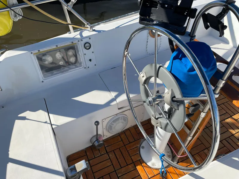 Slide: The Image of 1982 Catalina 30 sailboat cockpit with steering wheel and wooden deck. - 20