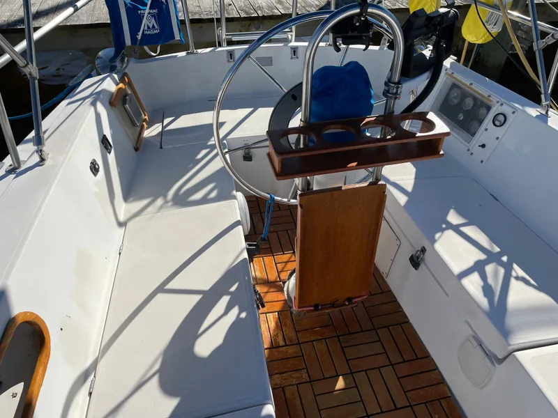 Slide: The Image of 1982 Catalina 30 sailboat cockpit with wooden flooring and steering wheel. - 21