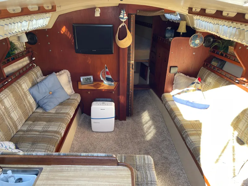 Slide: The Image of Interior of a 1982 Catalina 30 sailboat with cozy seating and nautical decor. - 26
