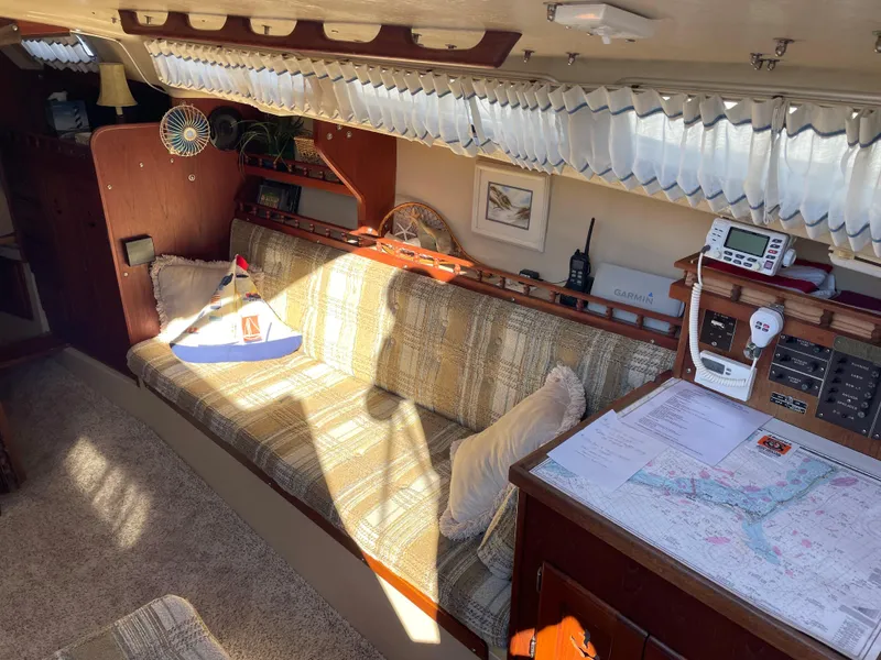 Slide: The Image of Interior of a 1982 Catalina 30 sailboat with cozy seating and navigation equipment. - 28
