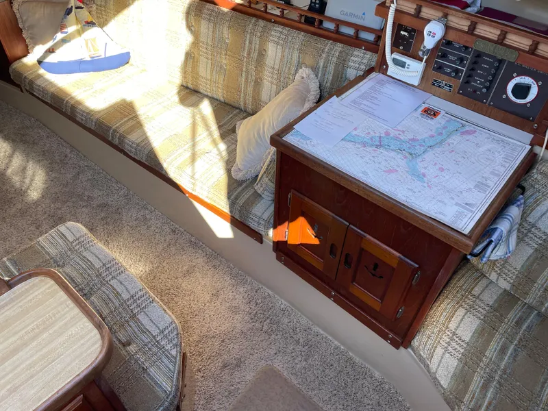 Slide: The Image of Interior of a 1982 Catalina 30 sailboat with navigation table and seating area. - 29
