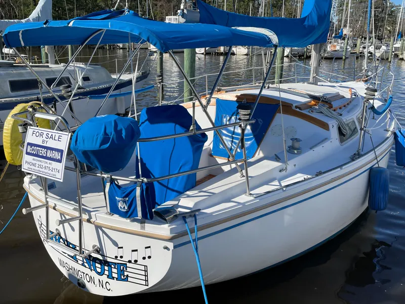 Slide: The Image of 1982 Catalina 30 sailboat for sale, docked in Washington, N.C., featuring blue covers and canopy. - 3