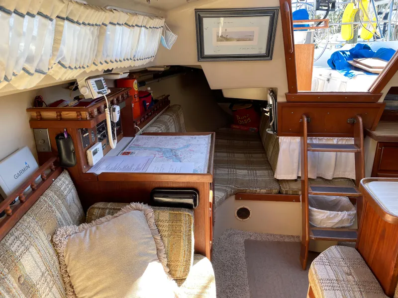 Slide: The Image of Interior of a 1982 Catalina 30 sailboat with cozy seating and navigation area. - 33