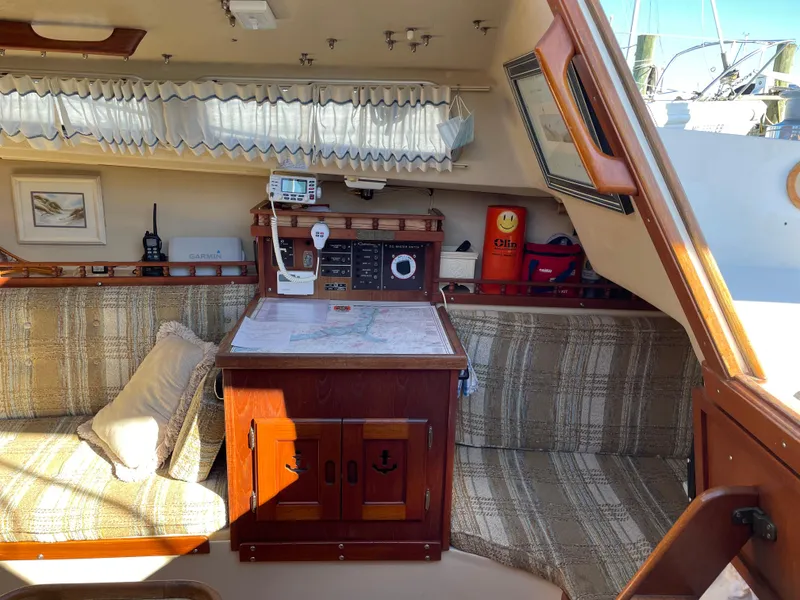 Slide: The Image of Interior of a 1982 Catalina 30 sailboat with navigation station and cozy seating area. - 39