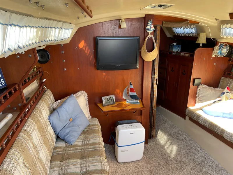 Slide: The Image of Interior of 1982 Catalina 30 sailboat with cozy seating and nautical decor. - 41