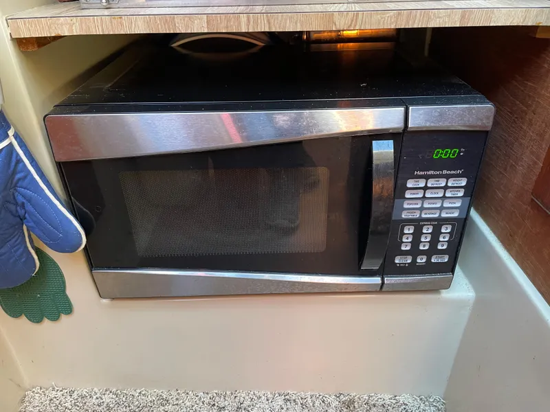 Slide: The Image of Microwave oven in a 1982 Catalina 30 boat kitchen, with digital display and control panel. - 47