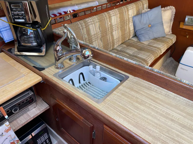 Slide: The Image of Compact kitchen area in a 1982 Catalina 30 sailboat with sink and coffee maker. - 48