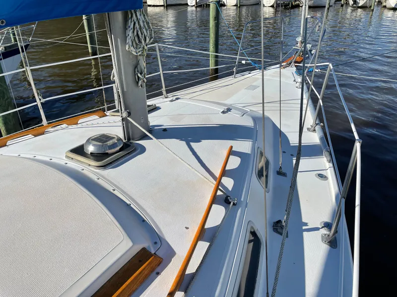 Slide: The Image of 1982 Catalina 30 sailboat deck with railing, docked at marina. - 6