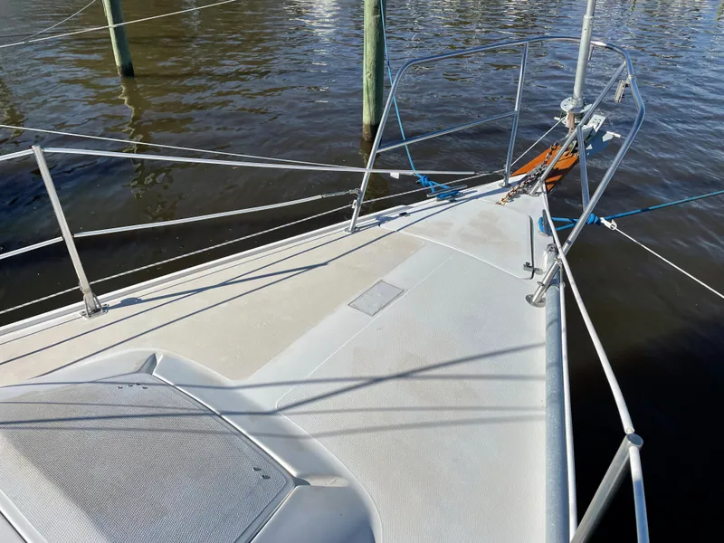 Slide: The Image of Bow of 1982 Catalina 30 sailboat docked on calm water. - 7