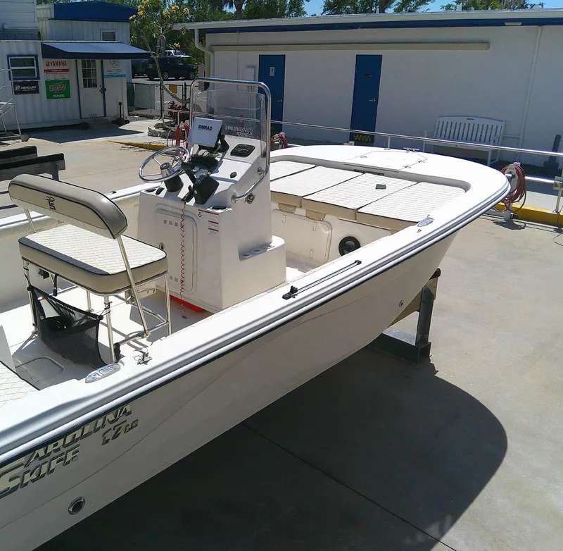 Slide: The Image of 2021 Carolina Skiff 17 LS boat displayed outdoors on a sunny day. - 2
