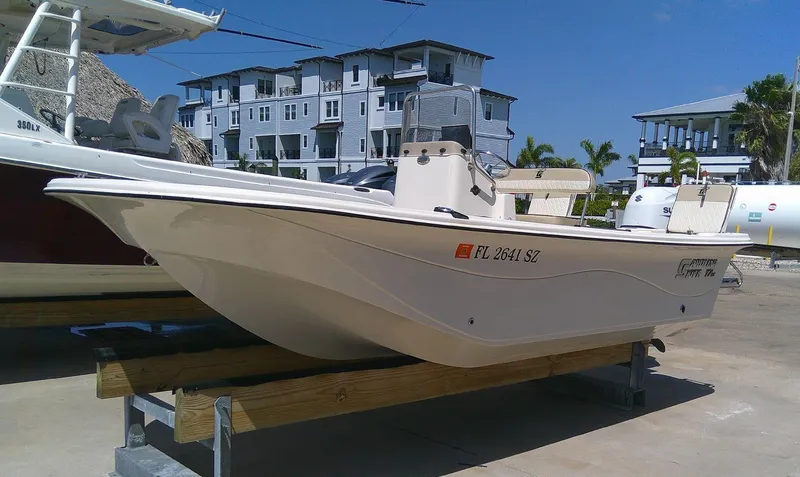 Slide: The Image of 2021 Carolina Skiff 17 LS boat on display, parked outdoors near modern buildings. - 3