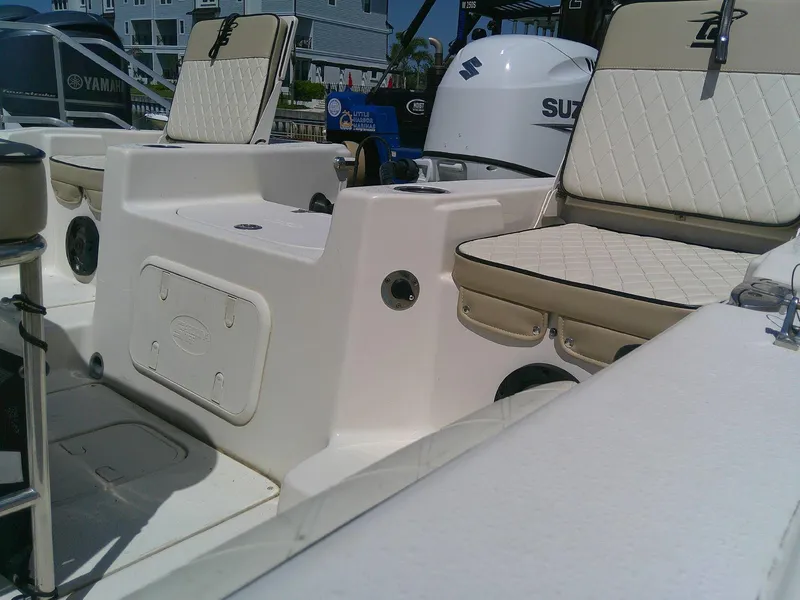 Slide: The Image of 2021 Carolina Skiff 17 LS boat interior with seating and Suzuki outboard motor. - 7