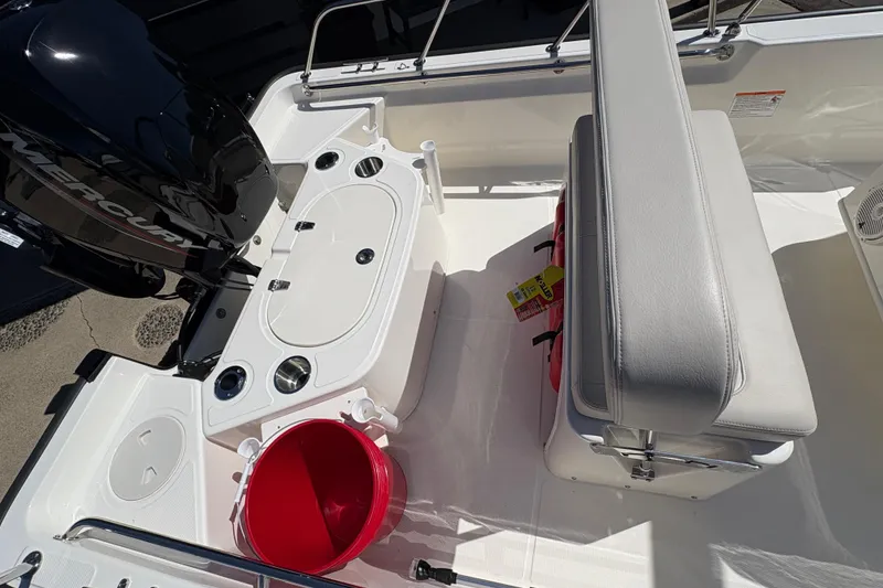Slide: The Image of 2026 Boston Whaler 150 Montauk boat interior with Mercury engine and seating area. - 5