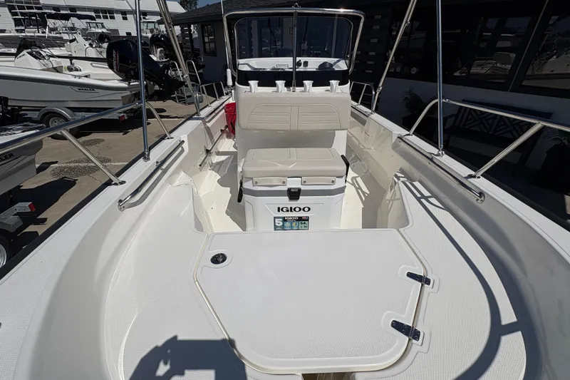 Slide: The Image of 2026 Boston Whaler 150 Montauk boat interior with seating and Igloo cooler. - 6
