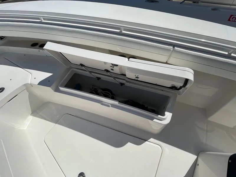 Slide: The Image of Open storage compartment on a 2022 Regulator 31 boat deck. - 11